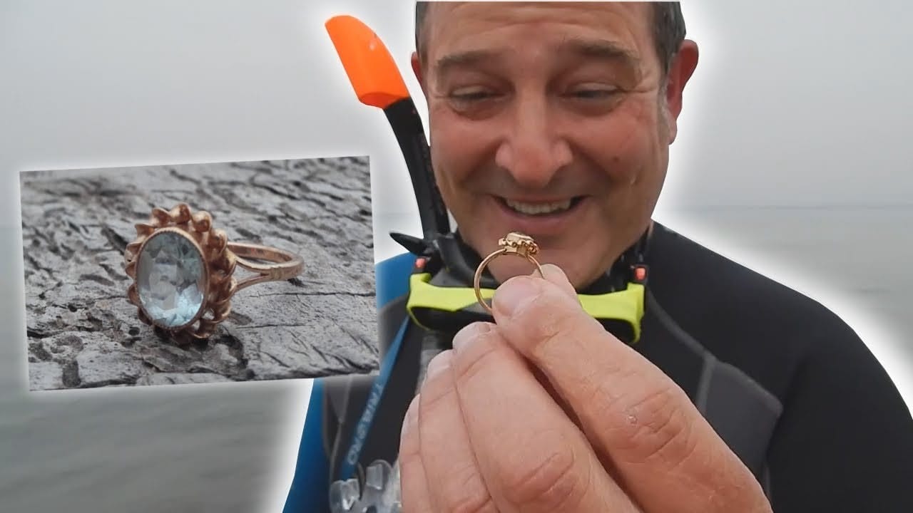 A diver showing a vintage ring found with the Scuba Tector